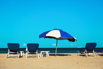 chairs on tropical sand beach