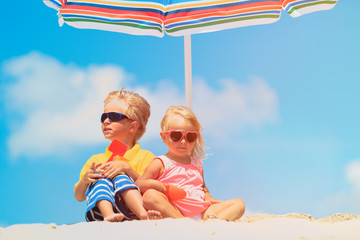 cute little boy and girl play at beach under parasol © nadezhda1906