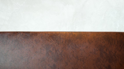 Vintage brown leather Sofa against white wall background.