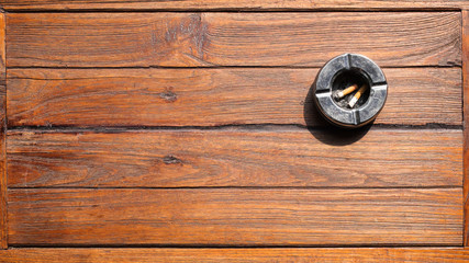 Ashtray and Cigarettes on wooden table Background.