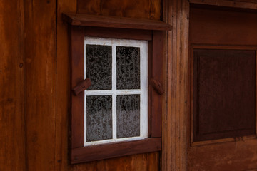 Obraz na płótnie Canvas A beautiful window of an old wooden scandinavian house