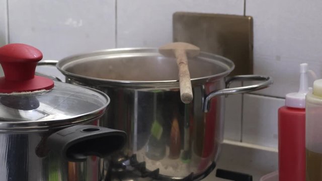 steel pot on the stove boils