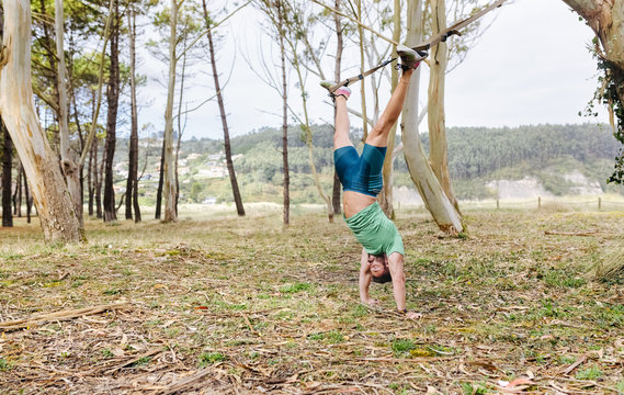 Man doing suspension training outdoors
