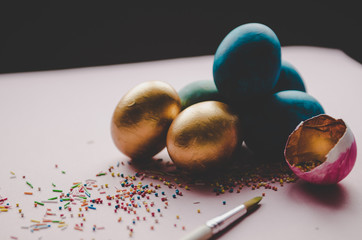 colorful blue and golden easter eggs with confectionery sprinkling