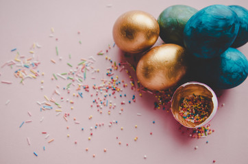 colorful blue and golden easter eggs with confectionery sprinkling