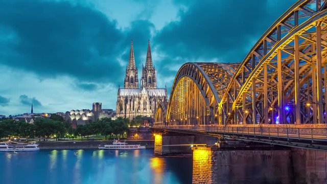 Cologne Cathedral and Hohenzollern Bridge in evening. Cologne, Germany (Static image with animated sky and water)
