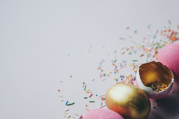 colorful pink and golden easter eggs with confectionery sprinkling