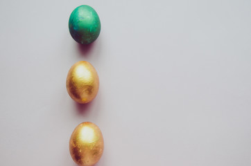 colorful green and golden easter eggs with confectionery sprinkling