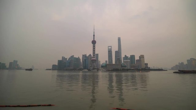 4K Timelapse of Shanghai from night to day, at The Bund with Huangpu River in Shanghai, China