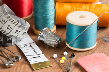 Spools of Thread and Basic Sewing Tools on Wooden Tabletop