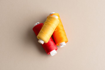 Spools of Yellow, Red, and Orange Thread