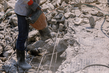 Construction worker  electric drill Drilling concrete ground in construction area