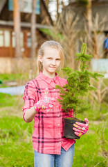Fototapeta premium Teen girl with tree seedling showing thumb up