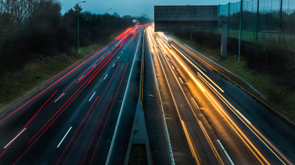Fototapeta na wymiar Car light trails on the highway in the early morning rush hour 