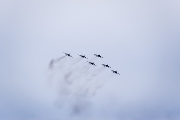 Air show in the sky above the Krasnodar airport flight school. Airshow in honor of Defender of the Fatherland. MiG-29 in the sky.