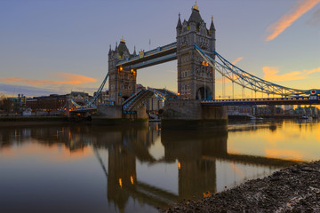 Fototapeta na wymiar The Tower Bridge lifting during sunrise. Shot from the Southwark side of River Thames.