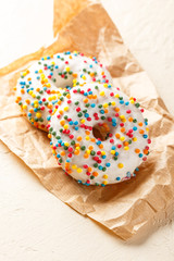 Donuts glazed with various sprinkles