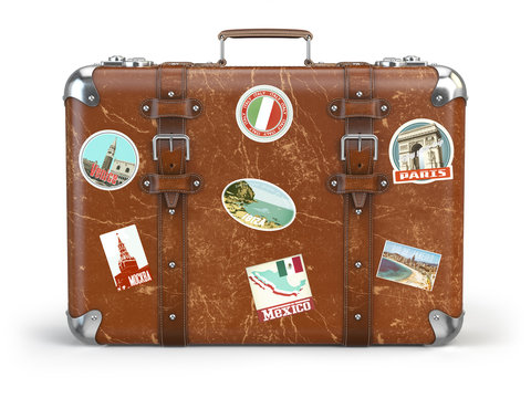 Old suitcase baggage with travel stickers isolated on white background.