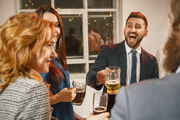 Group of friends enjoying evening drinks with beer