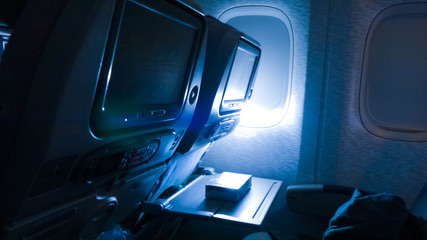 dim lights in the cabin of passenger aircraft during long-distance flights, passengers are rest