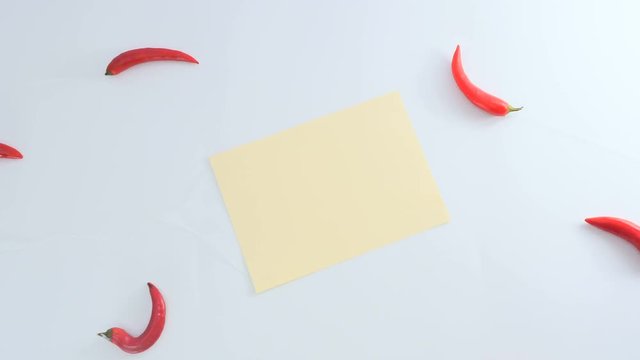 The chilli and piece of sheet is moving away from the white background