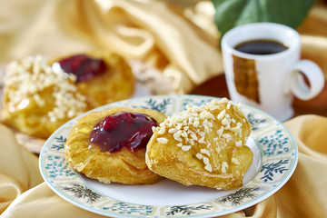 cheesecake with jam on a plate against the background of the cup with a sprig of red currants series full cooking food recipes