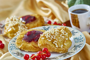 cheesecake with jam on a plate against the background of the cup with a sprig of red currants series full cooking food recipes