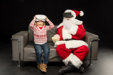Kid and Santa Claus in virtual reality headsets