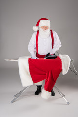 Santa Claus ironing coat