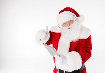 Santa Claus listening music with headphones