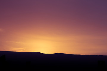 A beautiful, artistic, colorful sunset in Norway above mountains