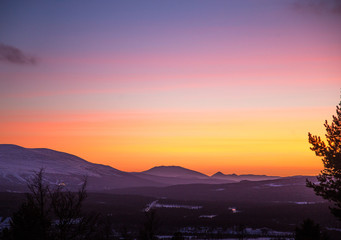 A beautiful, artistic, colorful sunset in Norway above mountains