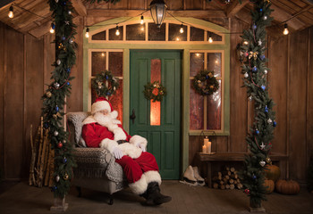 Obraz na płótnie Canvas Santa Claus sleeping in armchair