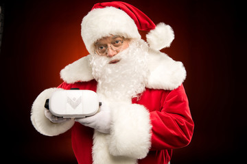 Santa Claus showing virtual reality headset