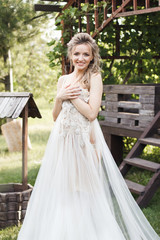 Fototapeta premium Wedding morning: beautiful bride trying on a wedding dress