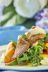 meat salad with green tomatoes on the plate blue background lot of food recipes