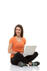Naklejka premium Teenager girl working with laptop.