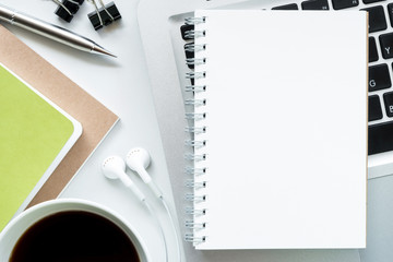 Plakat Blank notebook on top of modern white office desk table. Top view, flat lay.