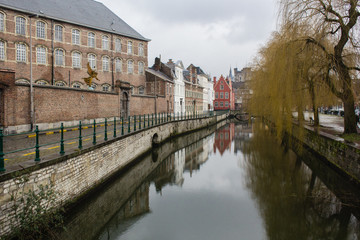 Fototapeta na wymiar View of canals and streets of Gent town, Belgium in rainy day in winter
