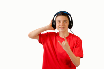 Teenage boy listening to music and making rock and roll gesture