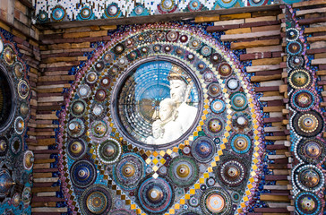 Buddha statue refelection on beautiful wall.