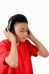 Teenage boy listening to music with his eyes closed