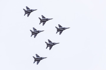 Air show in the sky above the Krasnodar airport flight school. Airshow in honor of Defender of the Fatherland. MiG-29 in the sky. - obrazy, fototapety, plakaty