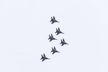 Air show in the sky above the Krasnodar airport flight school. Airshow in honor of Defender of the Fatherland. MiG-29 in the sky.