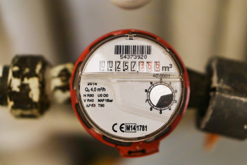 Water meter fitted to the mains system apartment. Industry concept.