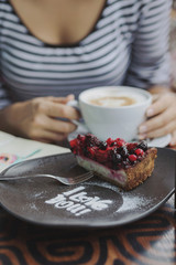 Young woman sitting indoor in urban cafe