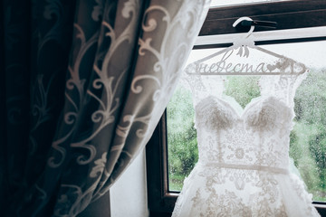 Wedding dress hanging on a window