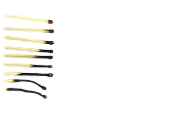 Row of burnt match at different stages isolated on white background