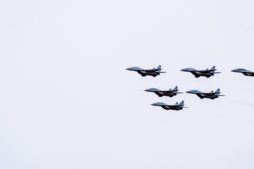 Air show in the sky above the Krasnodar airport flight school. Airshow in honor of Defender of the...