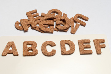wood alphabet letters on white background. Isolated conceptual image